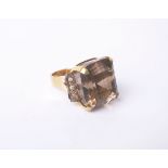 A large square smokey quartz ring with small eight-cut diamond three stone shoulders stamped '18ct',