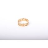 A modern gold broad band ring pierced with scrolls, indistinct marks, size O, 1.3g.