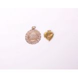 A gold heart-shaped locket, set with a small round ruby, 2.4g gross and a Continental gold round