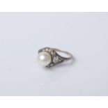 An early 20th century cultured-pearl and diamond cluster ring; the 8mm diameter cultured-pearl