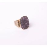 A 1960's gold and drusy amethyst oblong ring, the amethyst matrix in a closed back setting on a