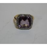 An early 20th Century platinum-flashed gold amethyst and diamond square cluster ring, milliegrain