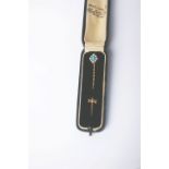 An early 20th century gold pin, oval cabochon turquoise, half-pearl and diamond cluster stick pin,