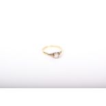 A diamond solitaire ring, the round brilliant approx.. 0.15cts, illusion set in white on a yellow