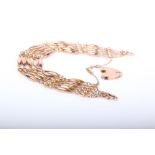 An early 20th century rose gold bracelet in the form of five rows of alternate torpedo and bead