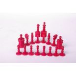 A bone chess set, red and white, king piece 9cm high, complete