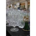 A large collection of cut table glass including spirit tumblers, wine glasses, champagne glasses,
