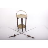 Two early fencing foils with 'butterfly' hilts and a two tier brass tray table