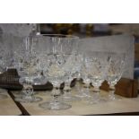 A collection of cut table glass, a decanter with plated spout, fruit bowls, silver plated gallery