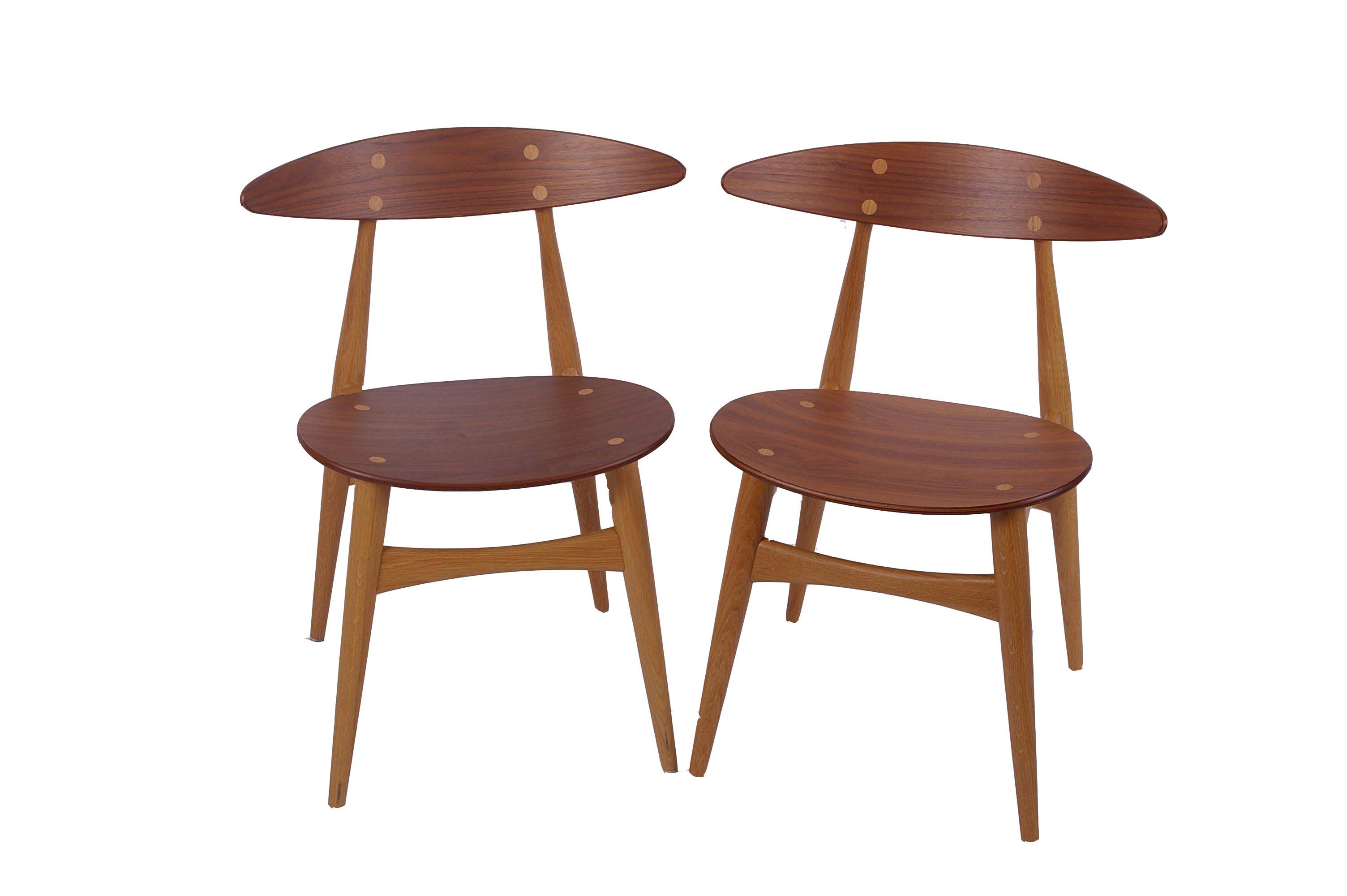 A pair of Carl Hansen two colour walnut and oak yoke back side/dining chairs, serial no's 201373 and