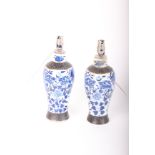 A pair of late 19th Century Chinese blue and white vases converted into lamps each with shade (