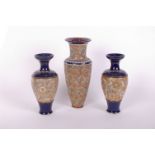 A pair of Doulton Lambeth baluster form blue and mottled gold panel vases (34cm high) and a similar