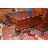 A Regency carved mahogany breakfast table, the rectangular hinged top containing two dummy