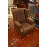 A George III style wing back armchair, leather covered and a leather covered bean bag