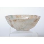 A pair of Chinese mutton fat jade bowls each with incised decoration of dragons to the exterior each