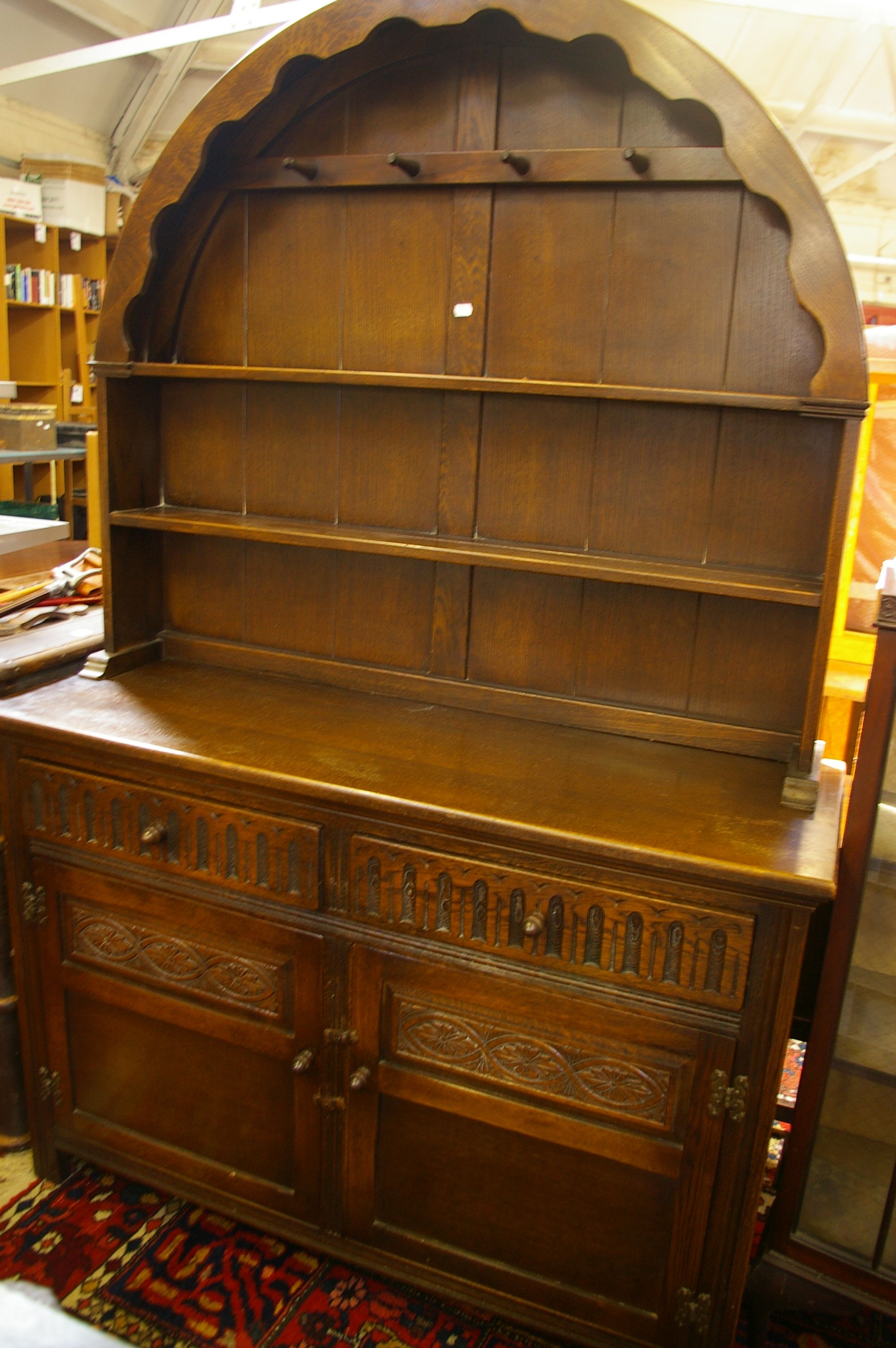 An oak arch top dresser with open shelf back, 122cm wide