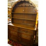 An oak arch top dresser with open shelf back, 122cm wide