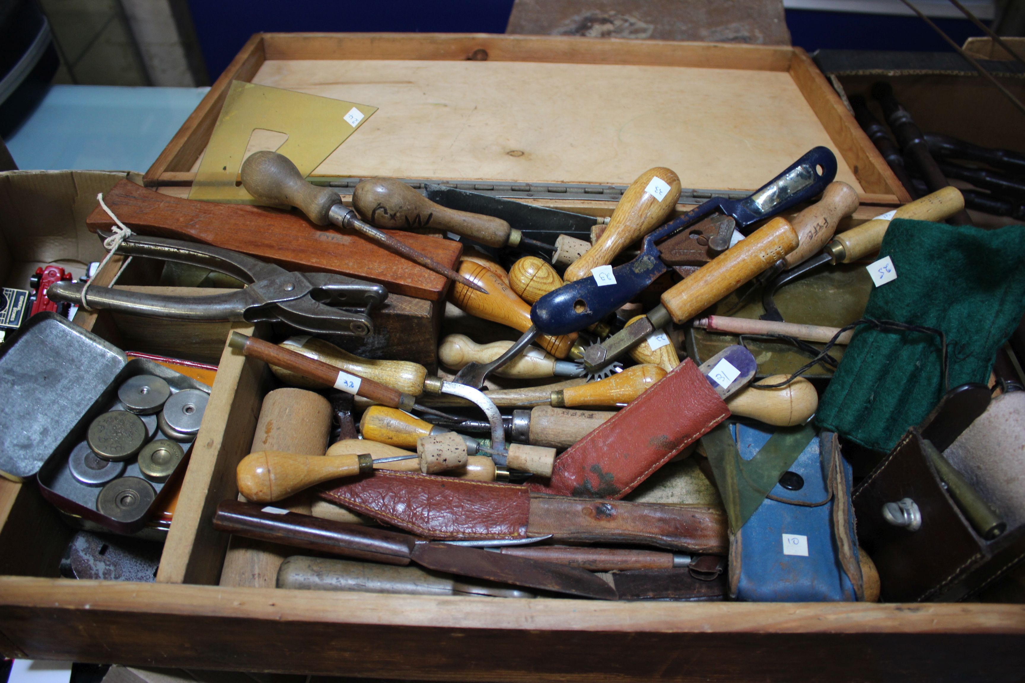 Leather working tools: a box containing specialist knives, punches, creasers, spoke shave, etc.,