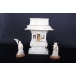 An early 20th Century ivory pagoda shrine, with relief carved panels centering a deity behind a pair