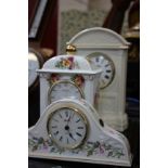 A reproduction wall clock, three ceramic cased mantel clocks and a banjo barometer