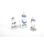 Four Royal Copenhagen figurines all geese with children, a large R/C model of two cockerel's (23cm