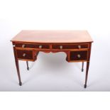 An Edwardian inlaid mahogany bow front dressing/writing table with four drawers and glass top
