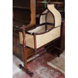 A pair of Victorian ebonised and mother of pearl inlay cane chairs and a mahogany and cane crib on