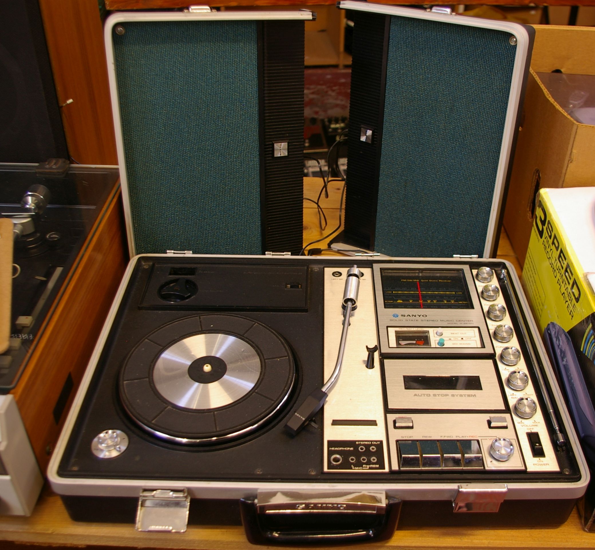 A vintage Sanyo solid state stereo music center in briefcase, with a Steepletone three speed