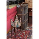 A bound trunk, walking sticks and a sewing basket on stand