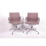 A set of four Eames for Vitra chrome chairs each with swivel seat