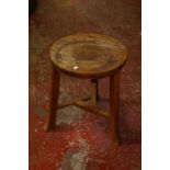 A 19th century or earlier elm cricket table with circular top, 42cm diameter; together with an