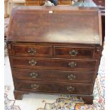 A George III style walnut and crossbanded bureau with two short and three long drawers on bracket