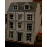 A modern dolls house together with furniture and fittings
