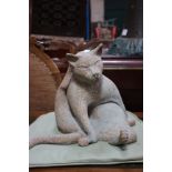 A pottery sculpture of a seated cat, underside marked 'EP3', antique finish and another sculpture of