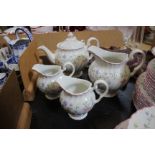 A Johnson Brothers floral pattern table service with pink rim (60 pieces) and a pottery 'Sun Face'