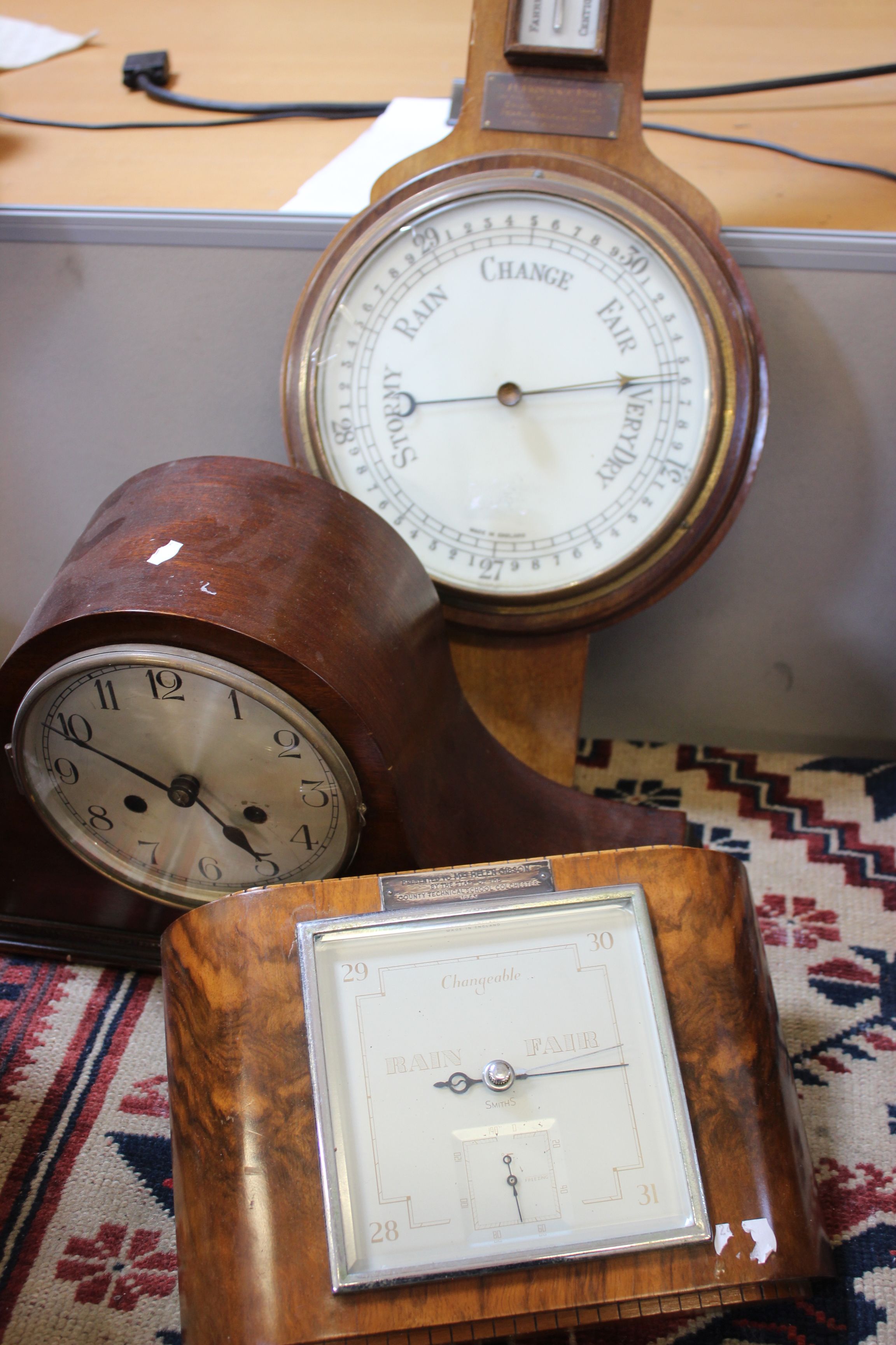 Three aneroid barometers and a 1940's mantel clock