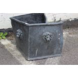 A lead cube planter with lion masks to all sides, 32cm. With damage