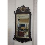 An 18th Century mahogany fretwork mirror with Ho-Ho bird cresting 95cm high, 52cm wide