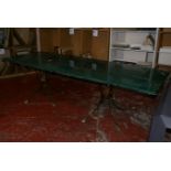 An unusual dining table with faux green marble rectangular top (resin) on gilt metal open stands.