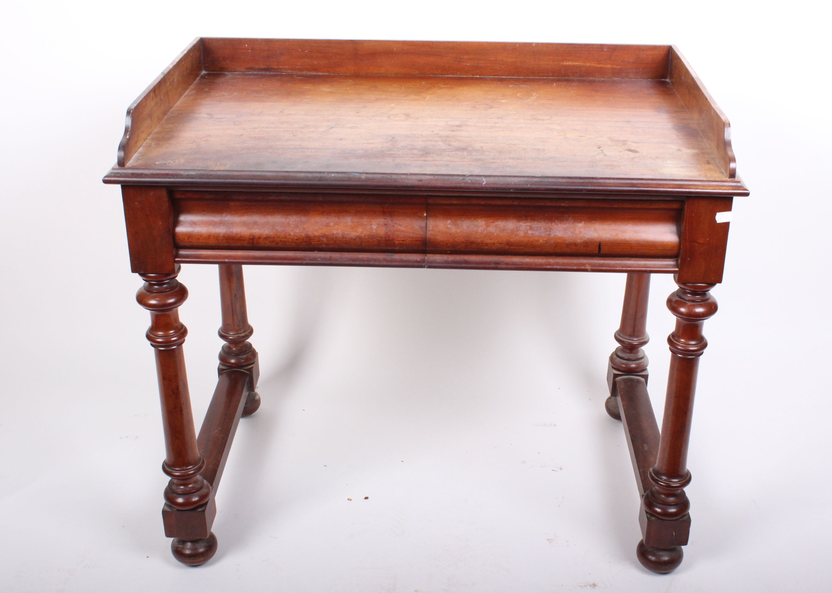 A Victorian mahogany dressing/writing table with short upstand and two drawers, 97cm wide