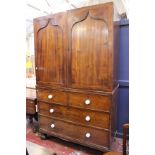 A Victorian mahogany linen press with arched doors enclosing linen slides, with two short and two