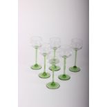 Sixty six identical tasting/hock stem wine glasses with green stems and decorations, 17cm high,