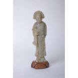 A Chinese carved soap stone figure, carrying a scroll on pedestal 24cm high