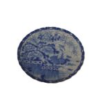 A Japanese blue and white platter with a scalloped edge decorated with flora and fauna 47cm diameter