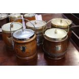 A collection of six oak biscuit barrels with silver plated mounts(one brass), all with vacant
