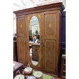 An Edwardian mahogany and crossbanded mirror door wardrobe 164cm wide