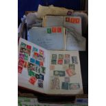 A box of stamps . Three albums of the world and Great Britain, also over 100 commercial mail items,