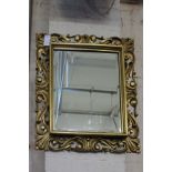 A large gilt framed mirror with bevelled glass 140cm x 106cm