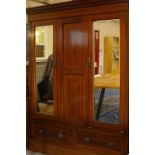 An Edwardian mahogany and crossbanded triple mirror wardrobe with drawers below 205cm high, 170cm