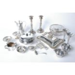 A collection of plated ware to include a pair of candlesticks, a glass bowl with plated rim, two